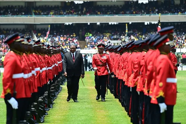 Outgoing Kenyan President uhuru kenyata inspects a guard of honour at the the Moi International Sports Center Kasarani in Nairobi, Kenya, on September 13, 2022 ahead of William Ruto inauguration ceremony. William Ruto was sworn in as Kenya's fifth post-independence president at a pomp-filled ceremony on Tuesday, after his narrow victory in a bitterly fought but largely peaceful election. Tens of thousands of people joined regional heads of state at a packed stadium in Nairobi to watch him take the oath of office, with many spectators clad in the bright yellow of Ruto's party and waving Kenyan flags. (Photo by Tony Karumba/AFP Photo)