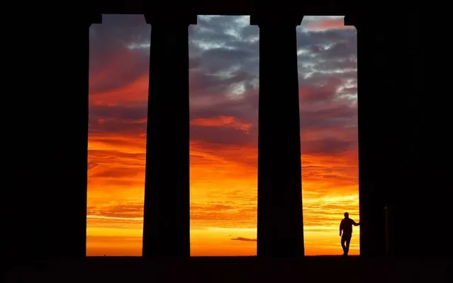 Through impressive neo-classical pillars, this spectacular sunrise was observed from Penshaw Monument near Sunderland this morning, October 23, 2017 – as this week temperatures are set to rise into the early 20s to end October on a warming high. (Photo by Paul Kingston/NNP)