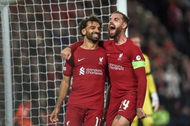 Mohamed Salah of Liverpool FC (L) celebrates with Jordan Henderson of Liverpool FC (R) after scoring a goal during the UEFA Champions League group A soccer match between Liverpool FC and Rangers FC in Liverpool, Britain, 04 October 2022. (Photo by Peter Powell/EPA/EFE)