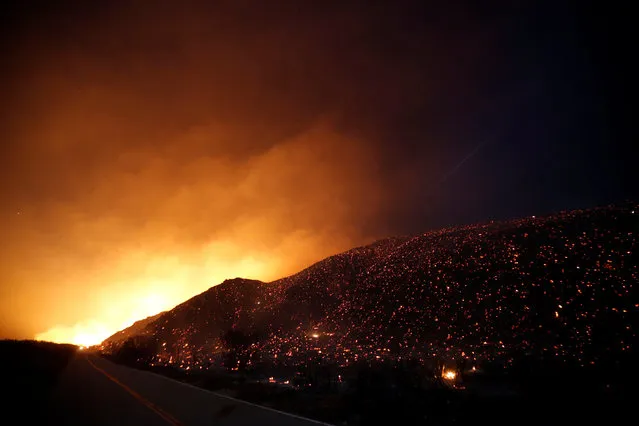 Embers glow as smoke fills the air at night along Lytle Creek Road during the Blue Cut fire in San Bernardino County, California, U.S. August 17, 2016. (Photo by Patrick T. Fallon/Reuters)
