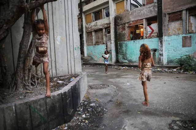 Young residents gather outside an occupied building in the Mangueira “favela” community, before the Brazil-Germany soccer final, on August 20, 2016 in Rio de Janeiro, Brazil. (Photo by Mario Tama/Getty Images,)