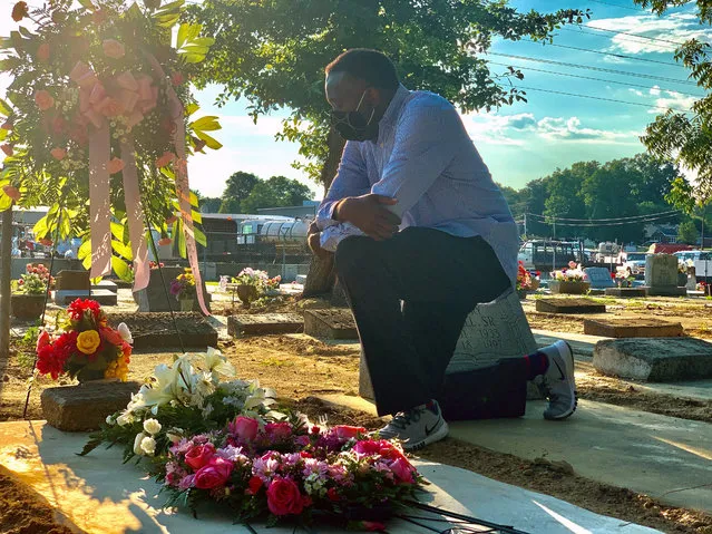 Will Boyd kneels at the grave of a family member who died after contracting the coronavirus, Saturday, June 20, 2020, in Montgomery, Ala. He says his family has lost multiple family members to COVID-19. (Photo by Kim Chandler/AP Photo)