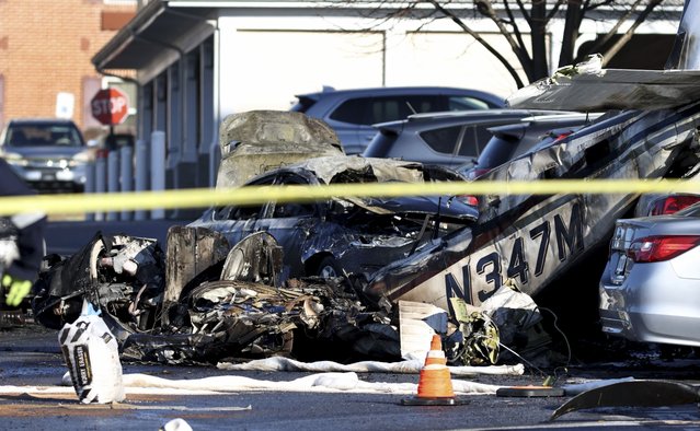 Debris is seen after a plane crashed in a parking lot of a retirement community Sunday, March 9, 2025, in Manheim Township, Pa. (Photo by Zach Gleiter/The Patriot-News via AP Photo)