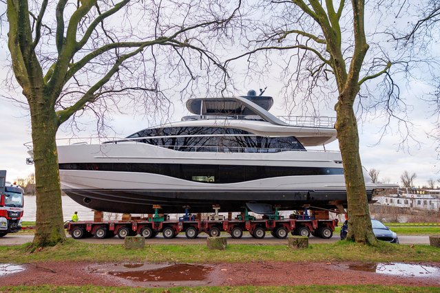 The Princess Y85, a 26-meter-long motor yacht weighing 67 tons, is seen after being lifted from the water of the Rhine river by a ship crane called “Big Willi”, in Dusseldorf, Germany, 05 January 2024. Dusseldorf is preparing for the water sports trade fair “Boot 2024”, one of the largest yacht and water sports trade fairs in the world. The fair will open its doors on 20 January until 28 January, with more than 1,500 exhibitors expected to present their products in 17 exhibition halls. The Princess Y85 is the first motor yacht that the “Big Willi” ship crane lifted from the water. (Photo by Christopher Neundorf/EPA/EFE)