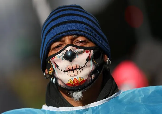 A demonstrator wearing a face mask is seen during a protest to demand resources for the vulnerable, amid the coronavirus disease (COVID-19) outbreak, in Buenos Aires, Argentina on July 24, 2020. (Photo by Agustin Marcarian/Reuters)