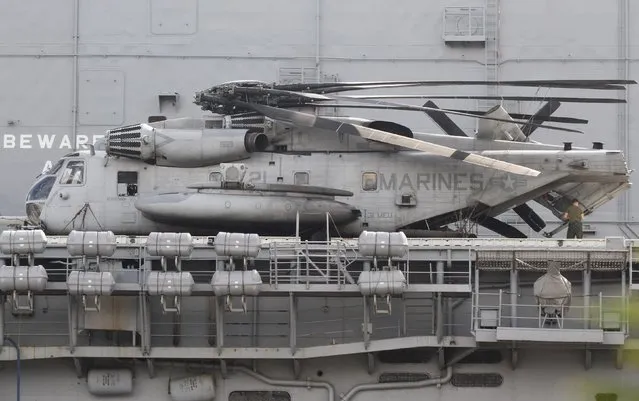 A Boeing Bell V-22 Osprey is seen onboard the USS Peleliu, an amphibious assault ship docked in Subic Bay, a former U.S. Navy base next to Olongapo, northwest of Manila, October 21, 2014. Philippine President Benigno Aquino rejected on Monday calls to tear up the Visiting Forces Agreement with the United States after an American serviceman was charged with the murder of a transgender Filipino outside a former U.S Navy base. (Photo by Lorgina Minguito/Reuters)