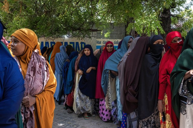 Women queue at the entrance of a building where civilians are registering to vote on April 23, 2025 in Mogadishu, Somalia. People registering told Getty Images they had been queueing for more than four hours. The country launched the first voter registration drive in over 50 years ahead of presidential elections planned for 2026. The country has long used an indirect, clan-based voting system, but its current president has pledged to implement a one-person, one-vote model. (Photo by Ed Ram/Getty Images)