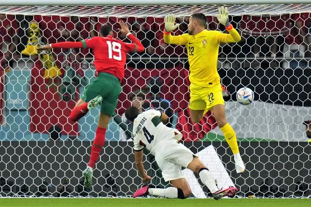 Morocco's Youssef En-Nesyri, left, attempts a head at goal to scores his side's opening goal during the World Cup quarterfinal soccer match between Morocco and Portugal, at Al Thumama Stadium in Doha, Qatar, Saturday, December 10, 2022. (Photo by Petr David Josek/AP Photo)