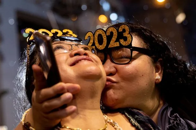A woman kisses her mother during a New Year's Eve party in Quezon City, Metro Manila, Philippines on December 31, 2022. (Photo by Eloisa Lopez/Reuters)