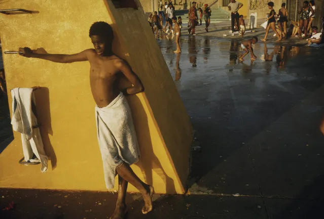 “Boy against a yellow platform at the Kosciusko Swimming Pool in the Bedford-Stuyvesant District of Brooklyn in New York City” New York, New York, July 1974. (Photo by Danny Lyon)