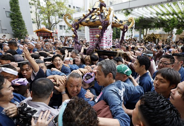 Revelers carry a mikoshi, or portable shrines, during the Sanja Matsuri festival in Tokyo, Japan, 18 May 2025. The Sanja Matsuri, a three-day annual festival, is one of Tokyo's most popular festivals and draws approximately two million visitors. (Photo by Franck Robichon/EPA)