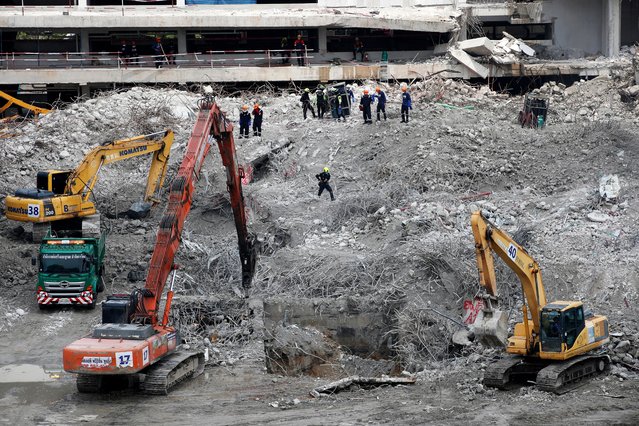 Rescue workers and construction machinery remove debris at the site of a building that collapsed following an earthquake, on the one-month anniversary of Myanmar's deadly earthquake, in Bangkok, Thailand, 28 April 2025. A 30-storey building of an under- construction State Audit Office tower collapsed following tremors from a 7.7-magnitude earthquake that struck Myanmar on 28 March. After one month, the death toll of the building collapse in Bangkok, as reported on 28 April 2025, has reached 63 people with nine injured and 31 remaining missing, according to the Bangkok Metropolitan Incident Command Center for Building Collapse. (Photo by Rungroj Yongrit/EPA/EFE)