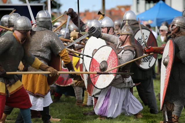 Opposing forces come together in a battle re-enactment at the Viking festival on April 13, 2024 in Sheringham, United Kingdom. The festival is run by Waffa Viking and Saxon Re-enactment Society and demonstrates traditional skills, battle reenactment, a torchlight procession and a boat burning finale. (Photo by MartinPope/Getty Images)