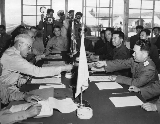 In this July 27, 1953 file photo, Maj. Gen. Blackshear M. Bryan, left, exchanges credentials with Communist Lt. Gen. Lee Sang Cho at the opening session of the Military Armistice Commission at the Panmunjom Conference House, in Panmunjom, North Korea. At Lee's right is Chinese Gen. Ting Kuo Jo, and next to him is Chinese Gen. Tsai Cheng Wen. In the corner of Asia where three Olympics – including the current one – are unfolding in the next four years, the political relationships are complex and easily misunderstood. (Photo by AP Photo)