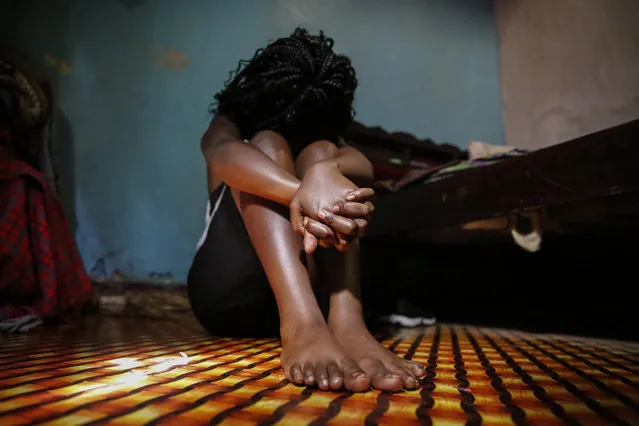 A teenage girl who became a s*x worker after schools in Kenya were closed in March due to coronavirus restrictions, sits in the rented room where she and others work, in Nairobi, Kenya Thursday, October 1, 2020. The girls saw their mothers' sources of income vanish when Kenya's government restricted movement to prevent the spread of the virus, and now engage in the s*x work to help with household bills. (Photo by Brian Inganga/AP Photo)