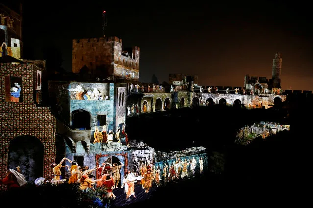 The citadel walls of the Tower of David Museum are illuminated during the “King David” light and sound show, in Jerusalem's Old City, March 11, 2018. (Photo by Ammar Awad/Reuters)