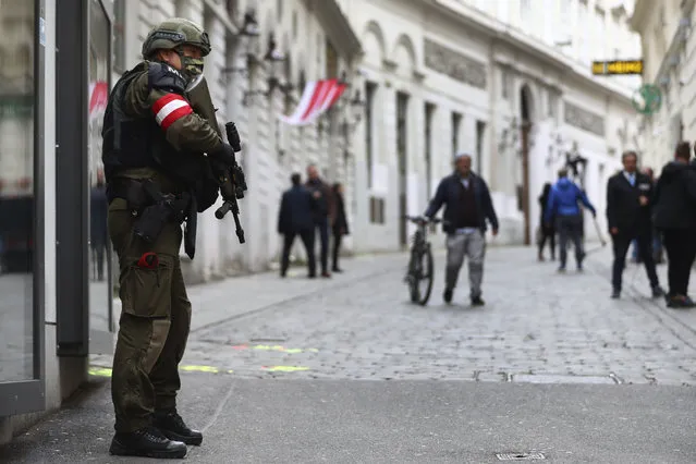 A military police officer guard at the crime scene near a synagogue in Vienna, Austria, Wednesday, November 4, 2020. Several shots were fired shortly after 8 p.m. local time on Monday, Nov. 2, in a lively street in the city center of Vienna. (Photo by Matthias Schrader/AP Photo)