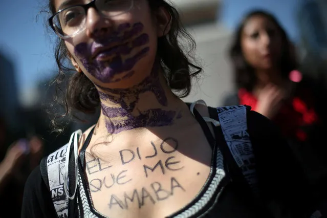 An activist takes part in a protest against violence against women, and of the murder of a 16-year-old girl in a coastal town of Argentina last week, at Angel de la Independencia monument, in Mexico, Mexico, October 19, 2016. The words read, “He said he loved me”. (Photo by Edgard Garrido/Reuters)