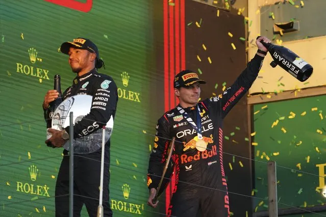 Red Bull driver Max Verstappen of Netherlands, right, and Mercedes driver Lewis Hamilton of Britain celebrate on the podium after the Australian Formula One Grand Prix at Albert Park in Melbourne, Sunday, April 2, 2023. Verstappen won the race and Hamilton took 2nd. (Photo by Scott Barbour/AP Photo)