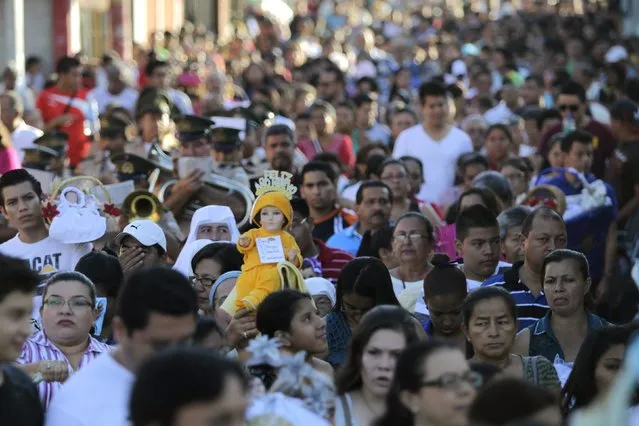 Catholics hold figurines of baby Jesus during a religious procession on Holy Innocents Day in Antiguo Cuscatlan, on the outskirts of San Salvador, December 28, 2014. (Photo by Jose Cabezas/Reuters)