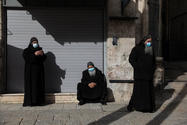 Christian monks near near Jaffa Gate during a nationwide COVID-19 third lockdown in the Old City of Jerusalem, 28 December 2020. Israel entered a general two-week lockdown for the third time to halt the wide spread of COVID-19. (Photo by Abir Sultan/EPA/EFE)