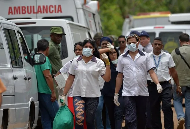 Emergency personnel at seen at the site of the accident after a Cubana de Aviacion aircraft crashed after taking off from Havana's Jose Marti airport on May 18, 2018. A Cuban state airways passenger plane with 113 people on board crashed on shortly after taking off from Havana's airport, state media reported. The Boeing 737 operated by Cubana de Aviacion crashed “near the international airport”, state agency Prensa Latina reported. Airport sources said the jetliner was heading from the capital to the eastern city of Holguin. (Photo by Adalberto Roque/AFP Photo)