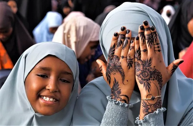 A Muslim faithful display her henna decoration before attending Eid al-Fitr prayers, marking the end of the fasting month of Ramadan, at the Masjid Salaam grounds in Nairobi, Kenya on April 21, 2023. (Photo by Monicah Mwangi/Reuters)