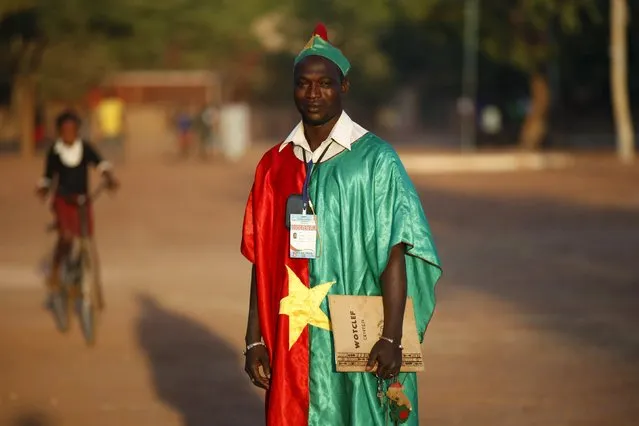 Election observer Blaise Kamate poses for a picture while wearing the flag of Burkina Faso during the presidential and legislative election in Ouagadougou, Burkina Faso, November 29, 2015. (Photo by Joe Penney/Reuters)