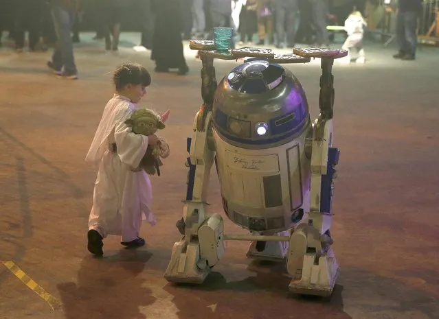 Audrey Mata from Washington D.C in the U.S. dressed as Princess Leia, comes face to face with a replica of R2-D2 at the  'For The Love of The Force' Star Wars fan convention in Manchester, northern England, December 4, 2015. (Photo by Phil Noble/Reuters)