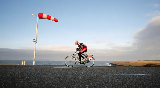 A participant in action during the third edition of the Dutch National Championship “Cycling against the Wind” at the Oosterscheldekering (Eastern Scheldt storm surge barrier) near Neeltje Jans, Netherlands, 06 December 2015. (Photo by Bas Czerwinski/EPA)