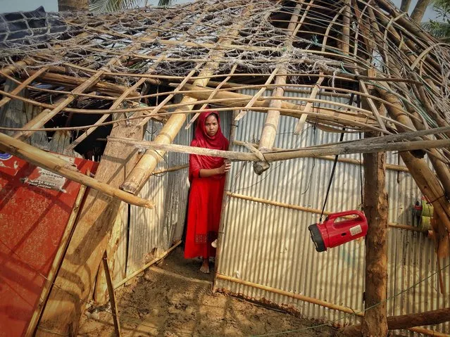 A woman surveys the damage caused to her home by Cyclone Mocha at Saint Martin island in Cox's Bazar, Bangladesh, Monday, May 15, 2023. Mocha largely spared the Bangladeshi city of Cox's Bazar, which initially had been in the storm's predicted path. Authorities had evacuated hundreds of thousands of people before the cyclone veered east. (Photo by Al-emrun Garjon/AP Photo)