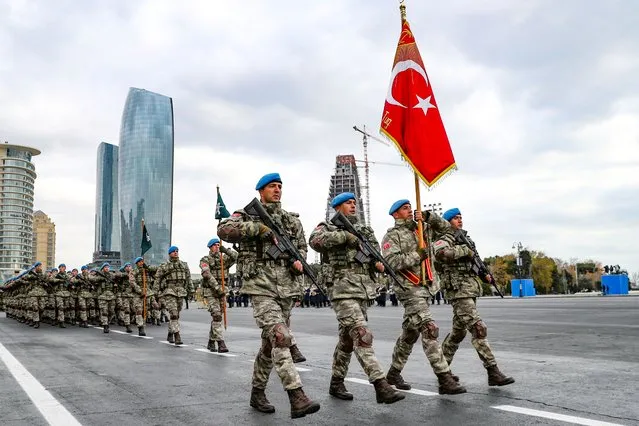 Members of a Turkish forces commando brigade take part in a military parade in which Turkey's President Recep Tayyip Erdogan and Azerbaijan's President Ilham Aliyev, looked on in Baku, Azerbaijan, Thursday, December 10, 2020. The massive parade was held in celebration of the peace deal with Armenia over Nagorno-Karabakh that saw Azerbaijan reclaim much of the separatist region along with surrounding areas. (Photo by AP Photo/Stringer)