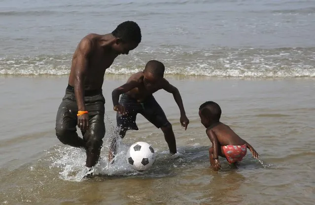 A family plays with a soccer ball on the beach on the Atlantic Ocean coast in Bata, in the Rio Muni region January 23, 2015. The African Nations Cup is being hosted by Equatorial Guinea from January 17 to February 8. (Photo by Amr Abdallah Dalsh/Reuters)