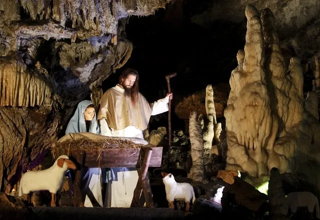 Actors perform the living Nativity biblical scenes in Postojna Cave in Postojna, Slovenia, December 22, 2015. (Photo by Srdjan Zivulovic/Reuters)