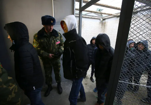 Vietnamese detained while attempting to cross the border illegally from Belarus to Lithuania, according to border officials, are seen in a temporary detention facility in Smorgon, Belarus, November 22, 2016. (Photo by Vasily Fedosenko/Reuters)