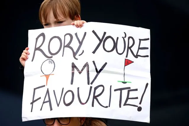 A young fan holds a sign reading 'Rory, you're my favourite!' during a practice round prior to The 151st Open at Royal Liverpool Golf Club on July 18, 2023 in Hoylake, England. (Photo by Andrew Redington/Getty Images)