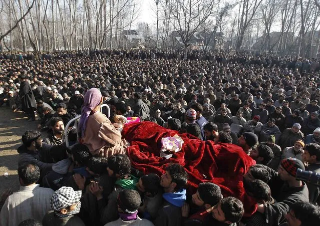 Kashmiri villagers carry the body of a civilian, Farooq Ahmad Bhat, during his funeral in Palhalan, north of Srinagar February 10, 2015. Bhat was killed and two others were injured on Monday in a clash between the Indian security forces and protesters who were demanding the mortal remains of Afzal Guru - a Kashmiri man, who was executed on February 9, 2013, for an attack on India's parliament in 2001, local media reported. (Photo by Danish Ismail/Reuters)