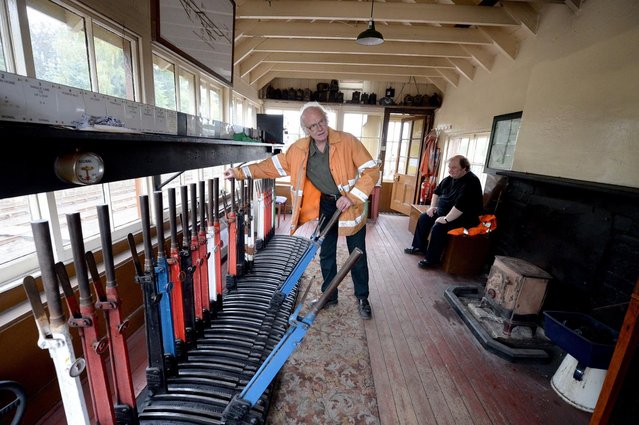 Signalman Jimmy Summers changes points at Boat of Garten station on the Strathspey Steam Railway on August 27, 2013 in Aviemore, Scotland. This year marks the 150th anniversary of the Highland Main Line built as a transportation link to the South for lairds and landowners living in northern Scotland. (Photo by Jeff J. Mitchell/Getty Images)