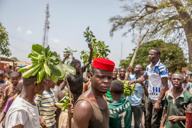 A man looks on as protesters erect makeshift barricades with tires and branches during a demonstration against Benin President Patrice Talon in Toui, an opposition stronghold, on April 7, 2021. President Talon is running for re-election in a vote on April 11, 2021, which he is favoured to win after critics say he cracked down on opponents. (Photo by Yanick Folly/AFP Photo)