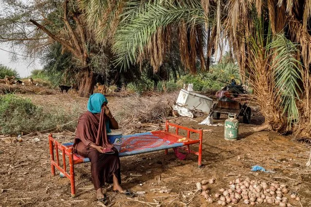 A woman sits outdoors on a salvaged bed in an area devastated by floods in al-Sagai north of Omdurman on August 6, 2023. Torrential rains have destroyed more than 450 homes in Sudan's north, state media reported on August 7, validating concerns voiced by aid groups that the wet season would compound the war-torn country's woes. Changing weather patterns saw Sudan's Northern State buffeted with heavy rain, causing damage to at least 464 houses, state-run SUNA news agency said. (Photo by AFP Photo/Stringer)