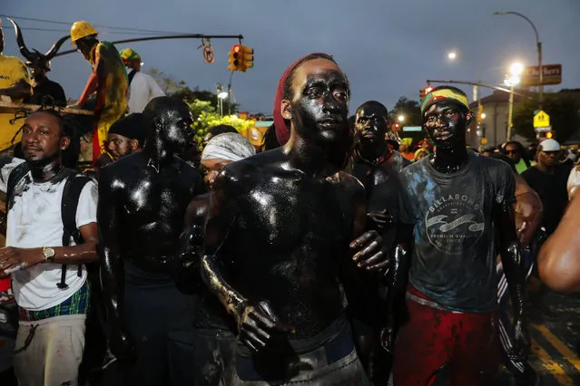 Revelers at dawn participate in J'Ouvert, an overnight celebration the night before the West Indies Day Parade in Brooklyn, NY on September 3, 2018. (Photo by Stephen Yang)