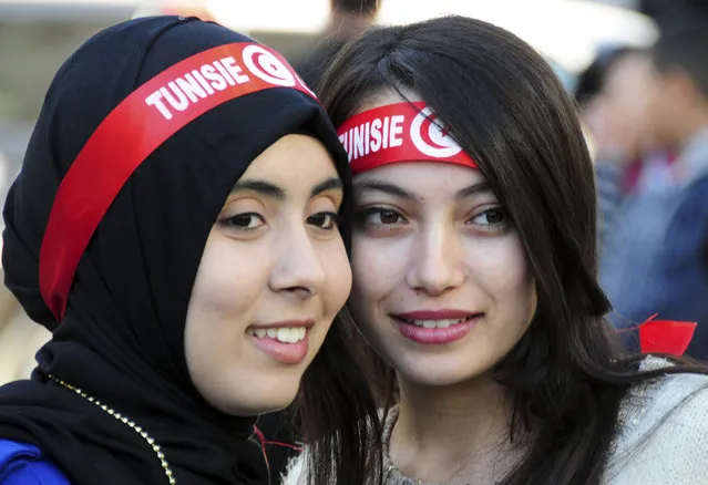 Tunisian girls attend a rally to mark the fifth anniversary of the Arab Spring, Thursday, January14, 2016 in Tunis. Tunisian teachers, activists and political parties have joined to celebrate five years since protesters drove out their autocratic president and ushered in a democratic era. The crowd at Thursday's rally included families of those killed in weeks of protests against President Zine el Abidine Ben Ali, who fled on Jan. 14, 2011. (Photo by Riadh Dridi/AP Photo)