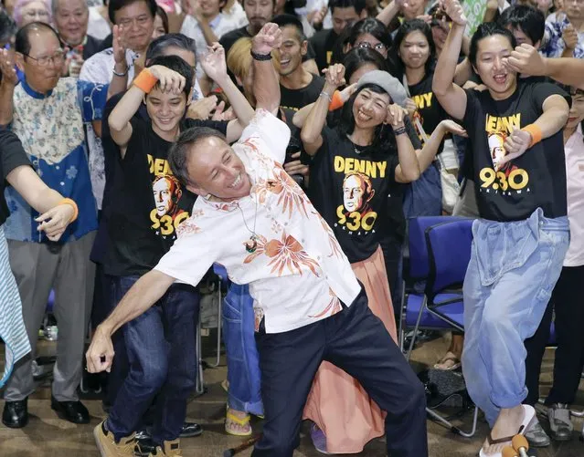 Japan's legislator Denny Tamaki celebrates his victory, dancing with supporters in the election for Okinawa governor in Naha city, Sunday, September 30, 2018. Tamaki, who campaigned criticizing the American military presence on the southwestern Japanese islands of Okinawa, won the election for governor Sunday, defeating a ruling party-backed candidate pushing the status quo. (Photo by Takuto Kaneko/Kyodo News via AP Photo)
