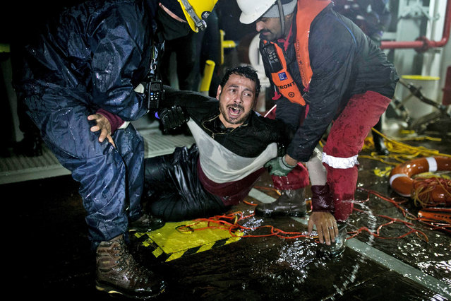 Ahmad Zarour, 32, from Syria, reacts after his rescue by  MOAS (Migrant Offshore Aid Station) while attempting to reach the Greek island of Agathonisi, Dodecanese, southeastern Agean Sea, overnight on January 16, 2016. Maltese-based NGO MOAS (Migrant Offshore Aid Station) rescued 48 migrants and refugees near Agathonisi island. (Photo by Angelos Tzortzinis/AFP Photo)