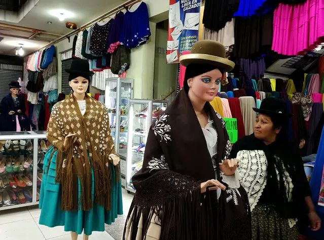 A customer browses a clothes shop selling Cholita (Andean Woman) fashion in La Paz, Bolivia, May 14, 2018. (Photo by David Mercado/Reuters)