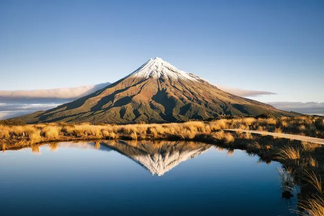Photo taken on June 22, 2021 shows a view of Mount Taranaki in New Zealand. At 2,308m, Mount Taranaki in Egmont National Park is the second highest peak on New Zealand’s North Island. Although it has not erupted since 1775, the volcano is still considered dormant rather than extinct. (Photo by Chine Nouvelle/SIPA Press/Rex Features/Shutterstock)