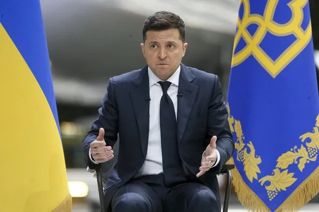 Ukrainian President Volodymyr Zelenskyy gestures while speaking to the media during a news conference with the world's largest airplane, Ukrainian Antonov An-225 Mriya in the background at the Antonov aircraft factory in Kyiv, Ukraine, Thursday, May 20, 2021. (Photo by Efrem Lukatsky/AP Photo)
