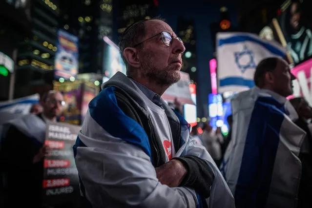 Members of the Jewish community and supporters of Israel attend a rally calling for the release of hostages held by Hamas, in Times Square, New York on October 19, 2023. The US intelligence community has estimated there were likely 100 to 300 people killed in the strike at the Ahli Arab hospital in Gaza, according to excerpts of a document seen October 19, 2023 by AFP – far fewer than the nearly 500 deaths that health authorities in the Hamas-ruled enclave originally described.  (Photo by Ed Jones/AFP Photo)