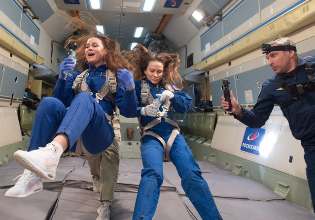 This handout picture released by the Gagarin Cosmonauts' Training Centre on October 17, 2023 shows Marina Vasilevskaya (L) flying during a parabolic flight aboard a zero-gravity simulator, a Russian IL-76 MDK aircraft used for cosmonauts' training flights in weightlessness, in Star City outside Moscow. Belavia flight attendant and spaceflight participant Marina Vasilevskaya of Belarus, along with NASA astronaut Tracy Dyson and Roscosmos cosmonaut Oleg Novitskiy, will blast off to the International Space Station (ISS) aboard the Soyuz MS-25 spacecraft in March 2024 and will spend approximately 12 days aboard the orbital complex. (Photo by Pavel Shvets/Gagarin Cosmonaut Training Center/AFP Photo)