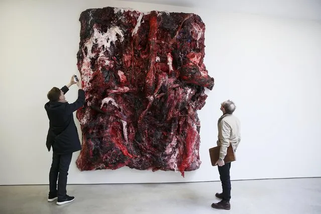Visitors look at untitled silicon artwork by British sculptor Anish Kapoor at the Lisson Gallery in London March 24, 2015. (Photo by Stefan Wermuth/Reuters)